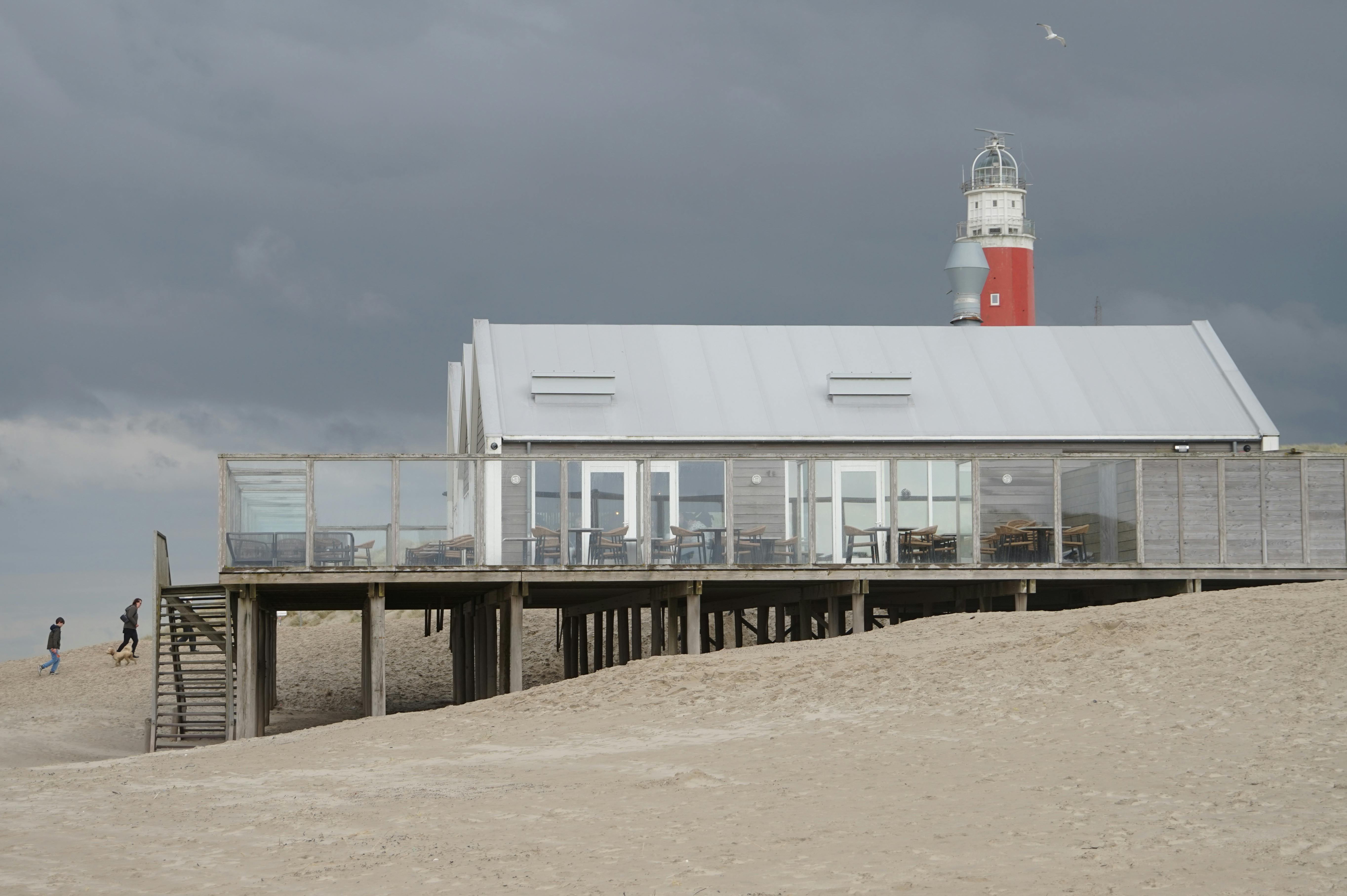 Texel lighthouse and beach pavilion under a moody Dutch sky
